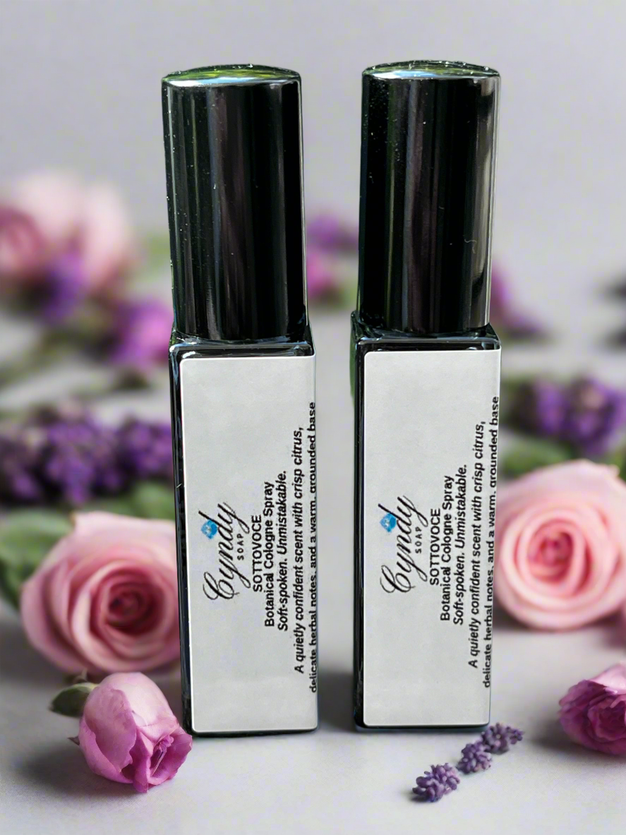 Sottovoce Cologne surrounded by roses, and lavender